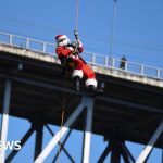 Abseiling Santa descends from Guatemala bridge to deliver toys