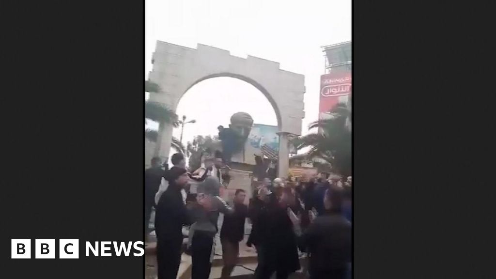 Statue of Bashar al-Assad's father toppled in Damascus suburb