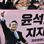 South Korea's impeached president Yoon defies arrest over failed martial law bid