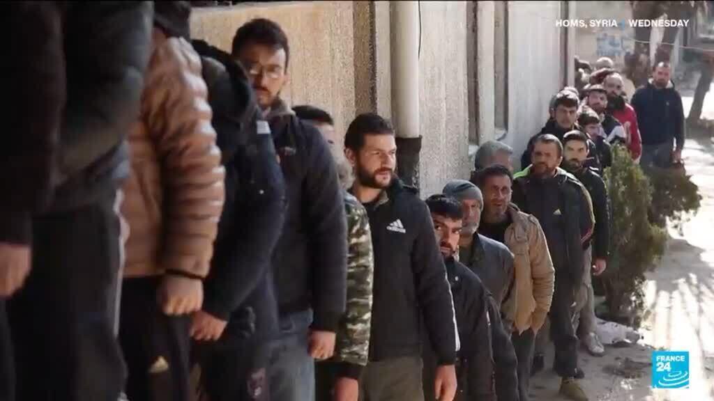 Former Syrian army soldiers line up to reconcile status with new government